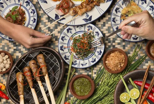 A shared Balinese table, satay and sides
