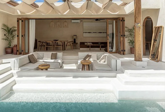 Open-plan villa lounge beside the pool