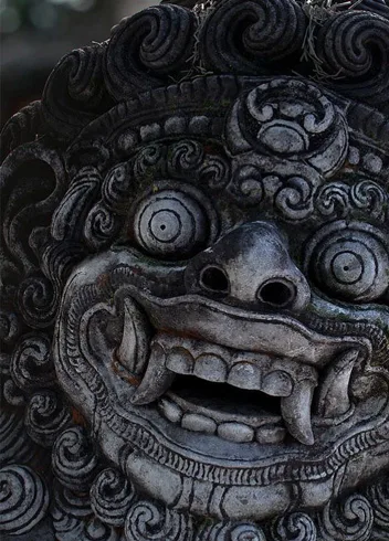 A carved Barong stone face, Ubud