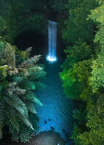 A jungle waterfall into a blue pool, Ubud